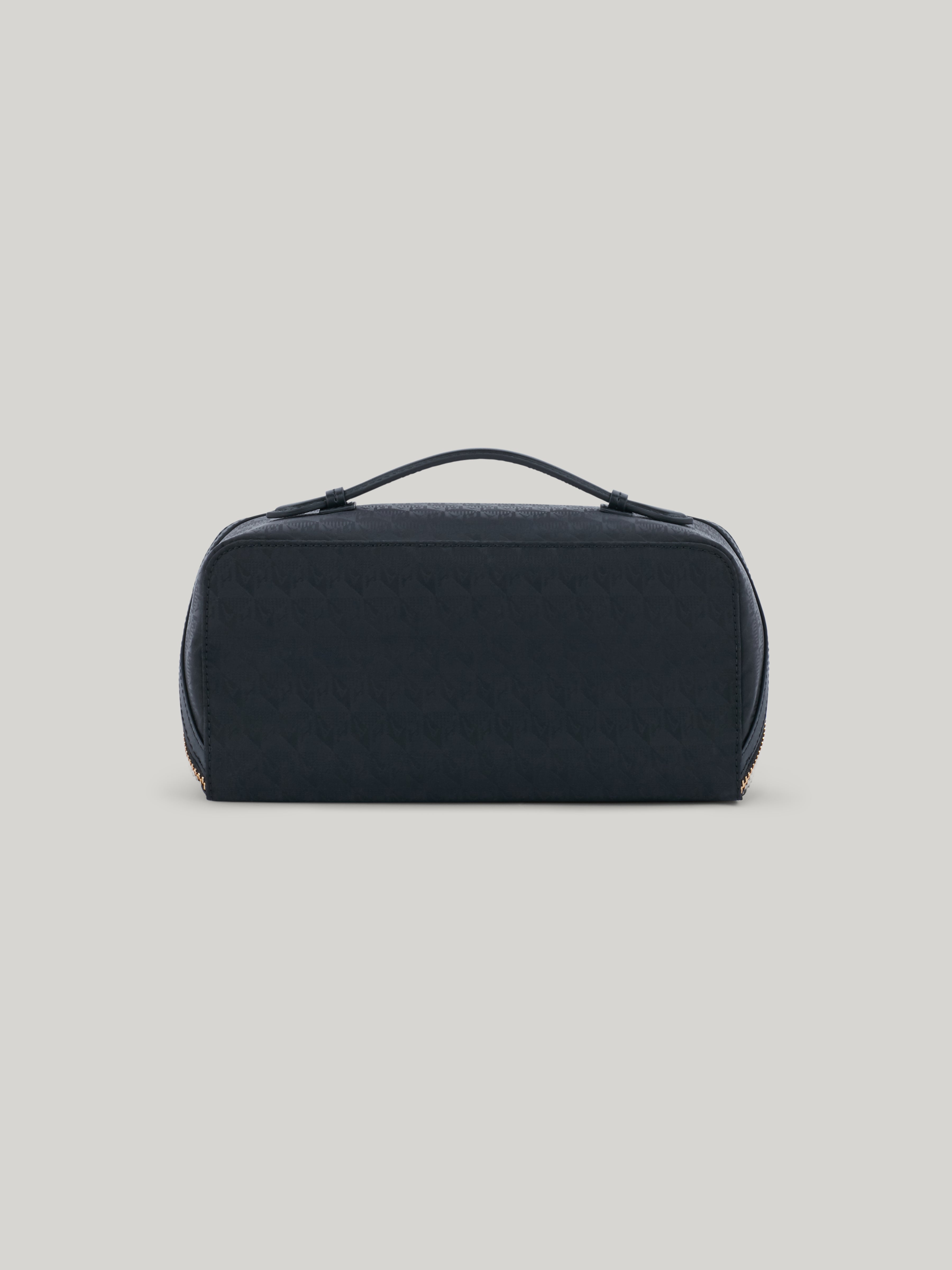 The epitome of functionality, the Anya Hindmarch Dressing Table opens up to lay flat, revealing a world of effortless organisation. With a central zip pocket and elasticated side pockets, there is a designated home for all of your beauty essentials. The easy-carry handle makes it your travel companion, bringing elegance and convenience wherever you go.