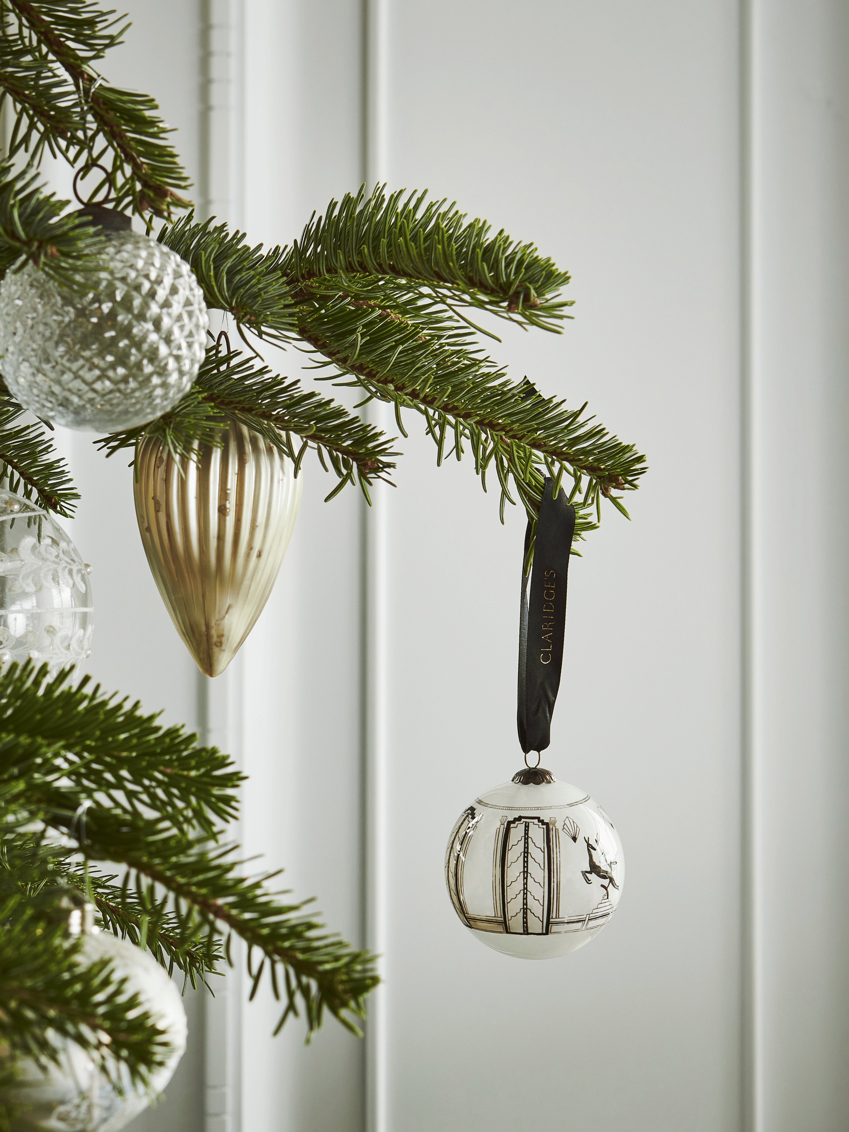 ﻿Deck the halls and dress the tree with the art deco style of Claridge’s.  Using a time-honoured ‘inside out’ painting technique, this hand-blown glass bauble depicts the leaping deer motif that features in Claridge's lobby.  The deer is a popular form in Art Deco design and our leaping deer was originally inspired by art deco lamps designed by Dreyfous. 