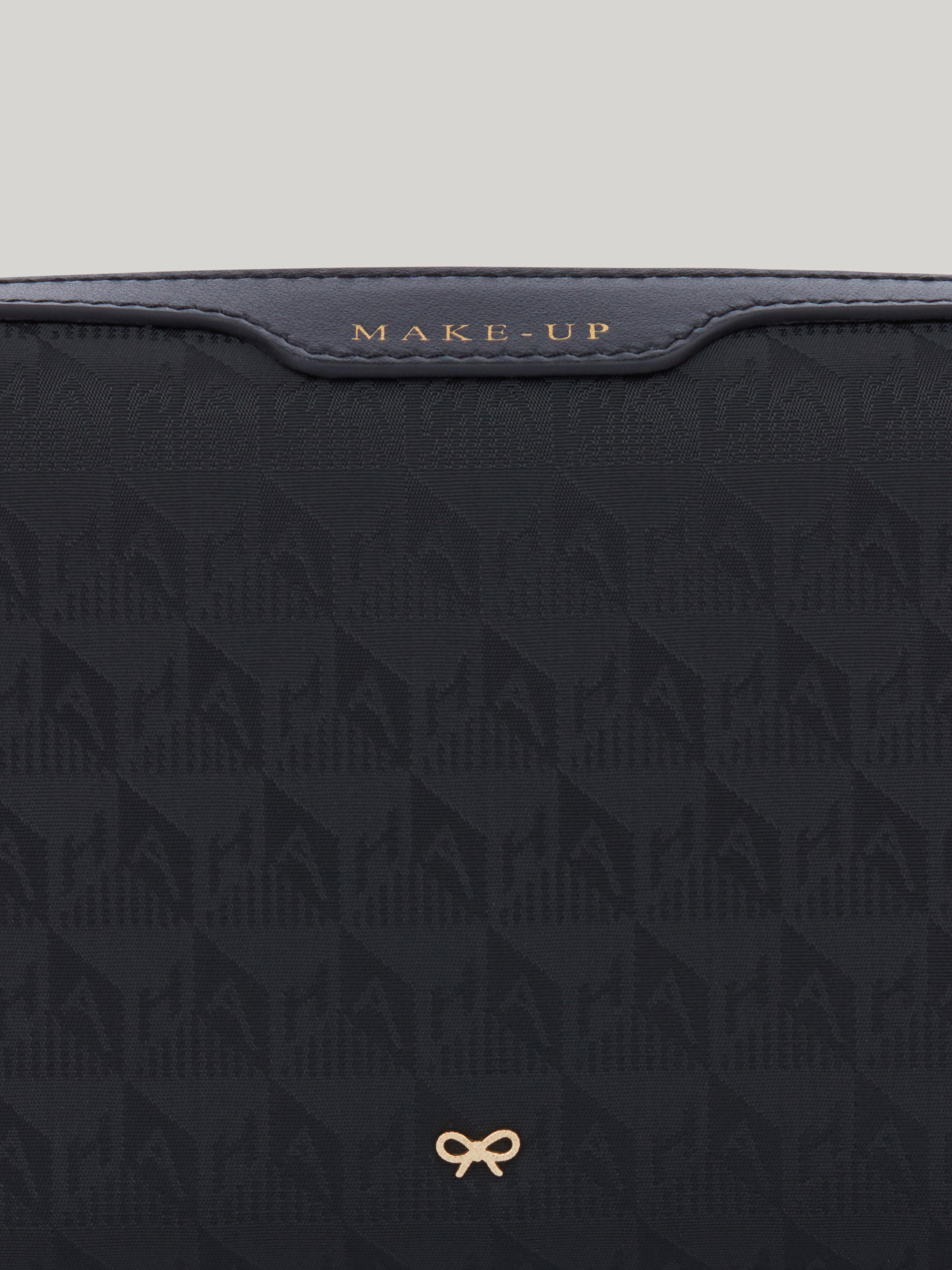 The Anya Hindmarch small make up pouch is perfect to carry your everyday essentials. Made from durable, monogrammed nylon, its spacious silhouette is split into two compartments, so you can keep your brushes safely stored and separate from your creams, blushers and bronzers in the second pocket.