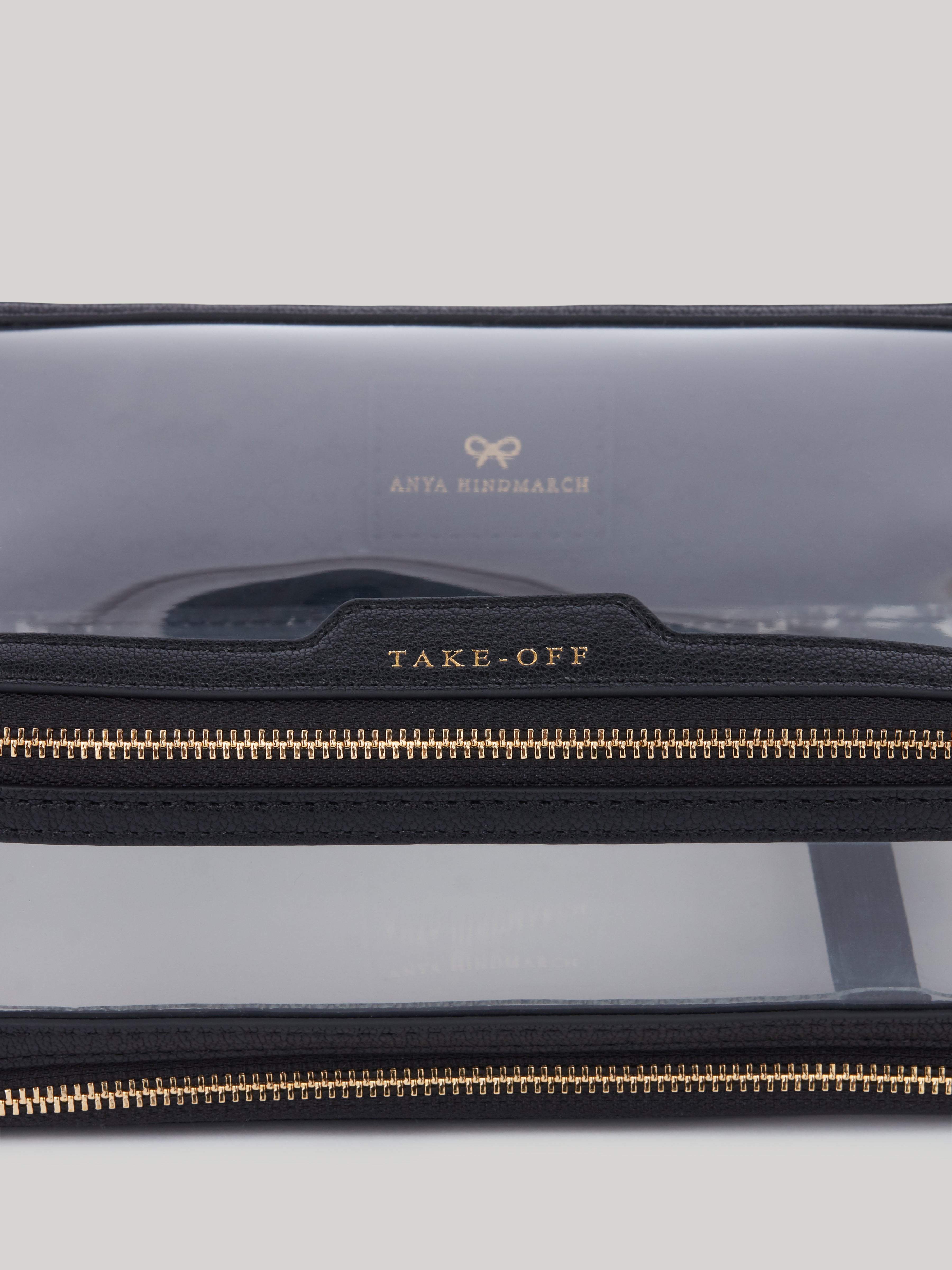 The Anya Hindmarch inflight case is the perfect travel accessory. With a clear exterior to help you instantly find what you're looking for, the case has two zipped compartments. Beautifully finished with patent trim, tassel zip fastenings and Anya Hindmarch bow. The transparent In-Flight case has individual sections labelled for TAKE OFF and TOUCH DOWN.