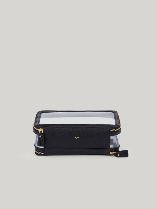 The Anya Hindmarch inflight case is the perfect travel accessory. With a clear exterior to help you instantly find what you're looking for, the case has two zipped compartments. Beautifully finished with patent trim, tassel zip fastenings and Anya Hindmarch bow. The transparent In-Flight case has individual sections labelled for TAKE OFF and TOUCH DOWN.