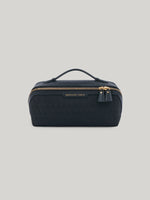 The epitome of functionality, the Anya Hindmarch Dressing Table opens up to lay flat, revealing a world of effortless organisation. With a central zip pocket and elasticated side pockets, there is a designated home for all of your beauty essentials. The easy-carry handle makes it your travel companion, bringing elegance and convenience wherever you go.