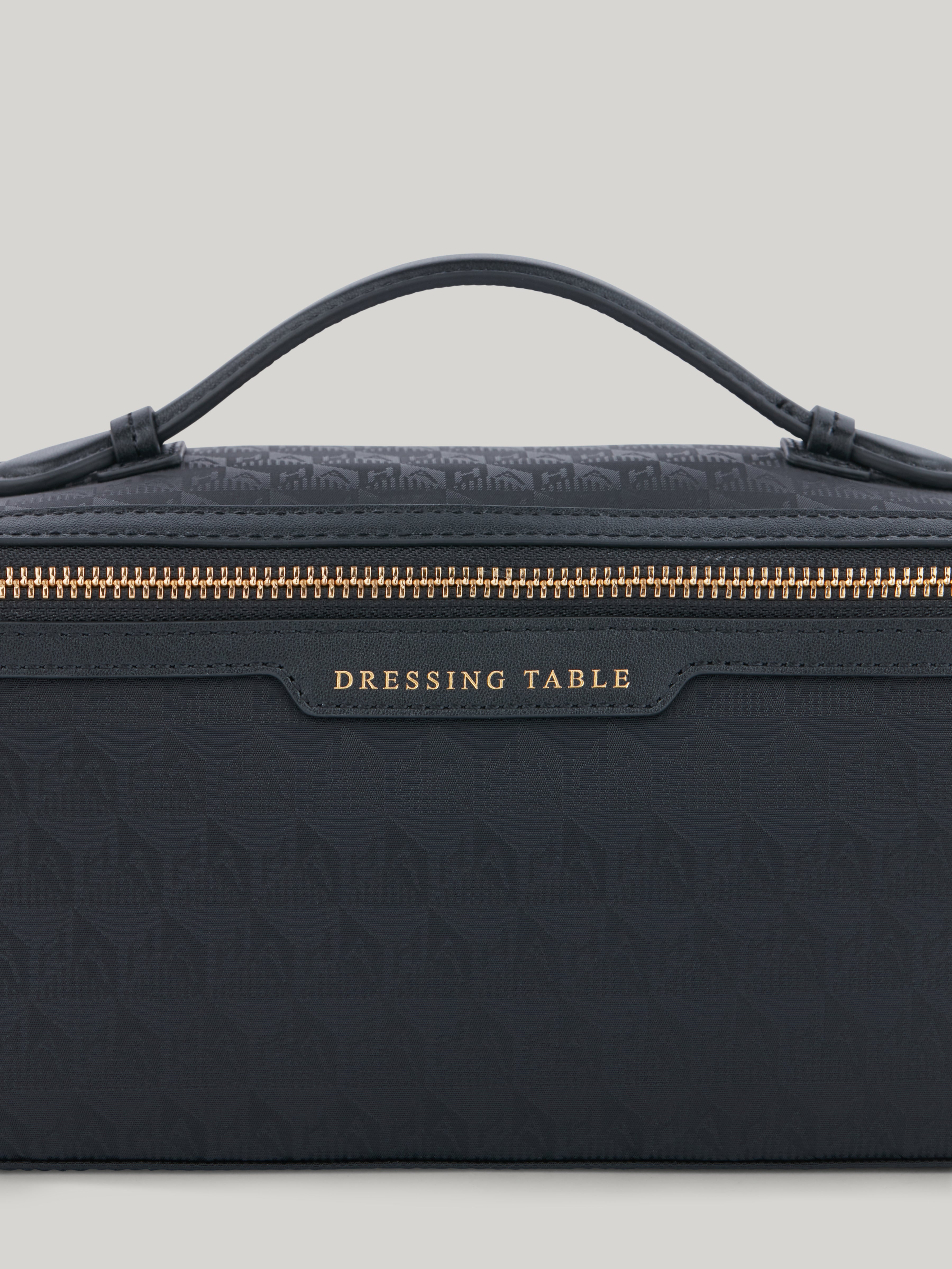 The epitome of functionality, the Anya Hindmarch Dressing Table opens up to lay flat, revealing a world of effortless organisation. With a central zip pocket and elasticated side pockets, there is a designated home for all of your beauty essentials. The easy-carry handle makes it your travel companion, bringing elegance and convenience wherever you go.