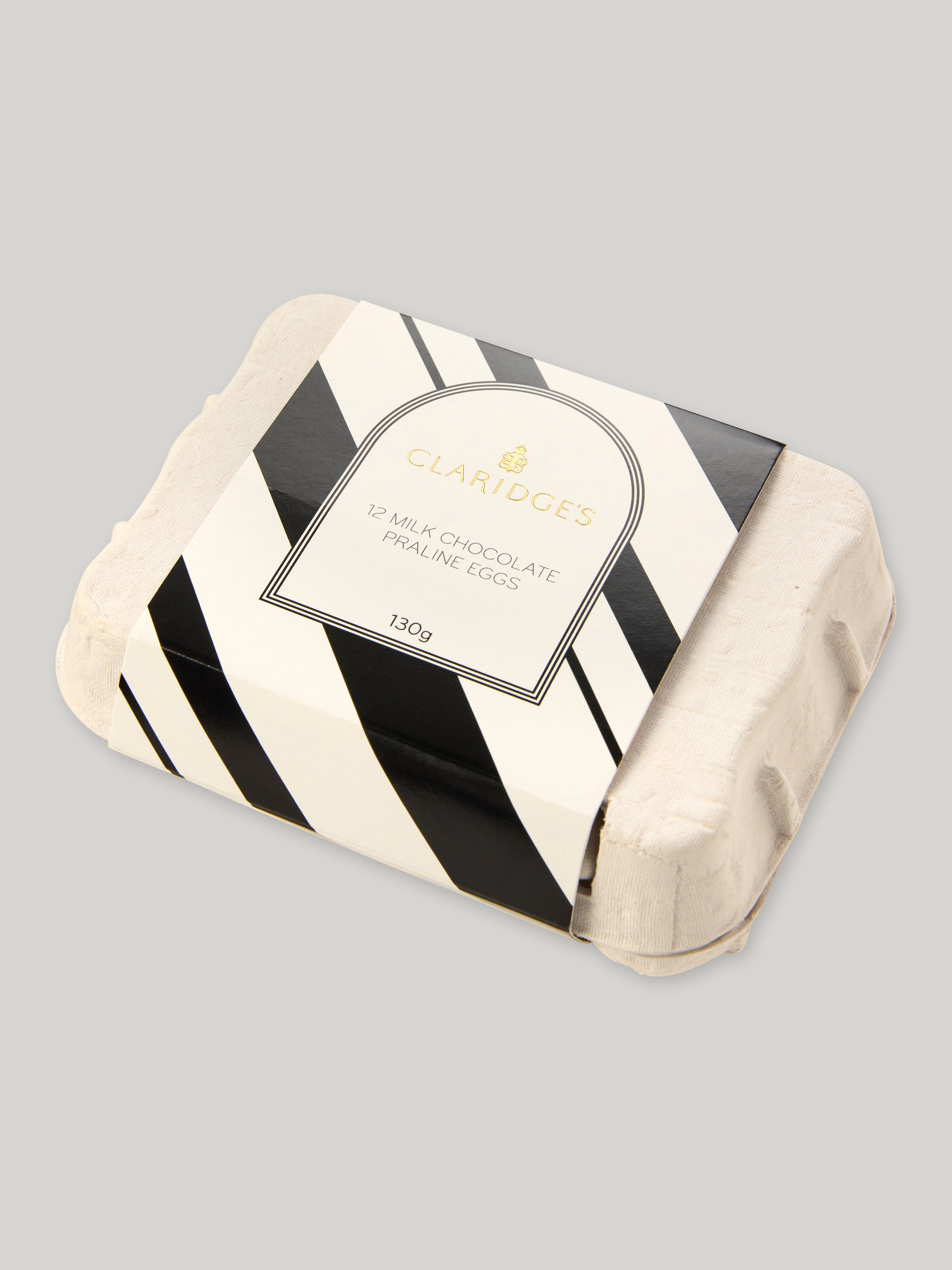 Egg carton with a black and white striped wrapper on a grey background
