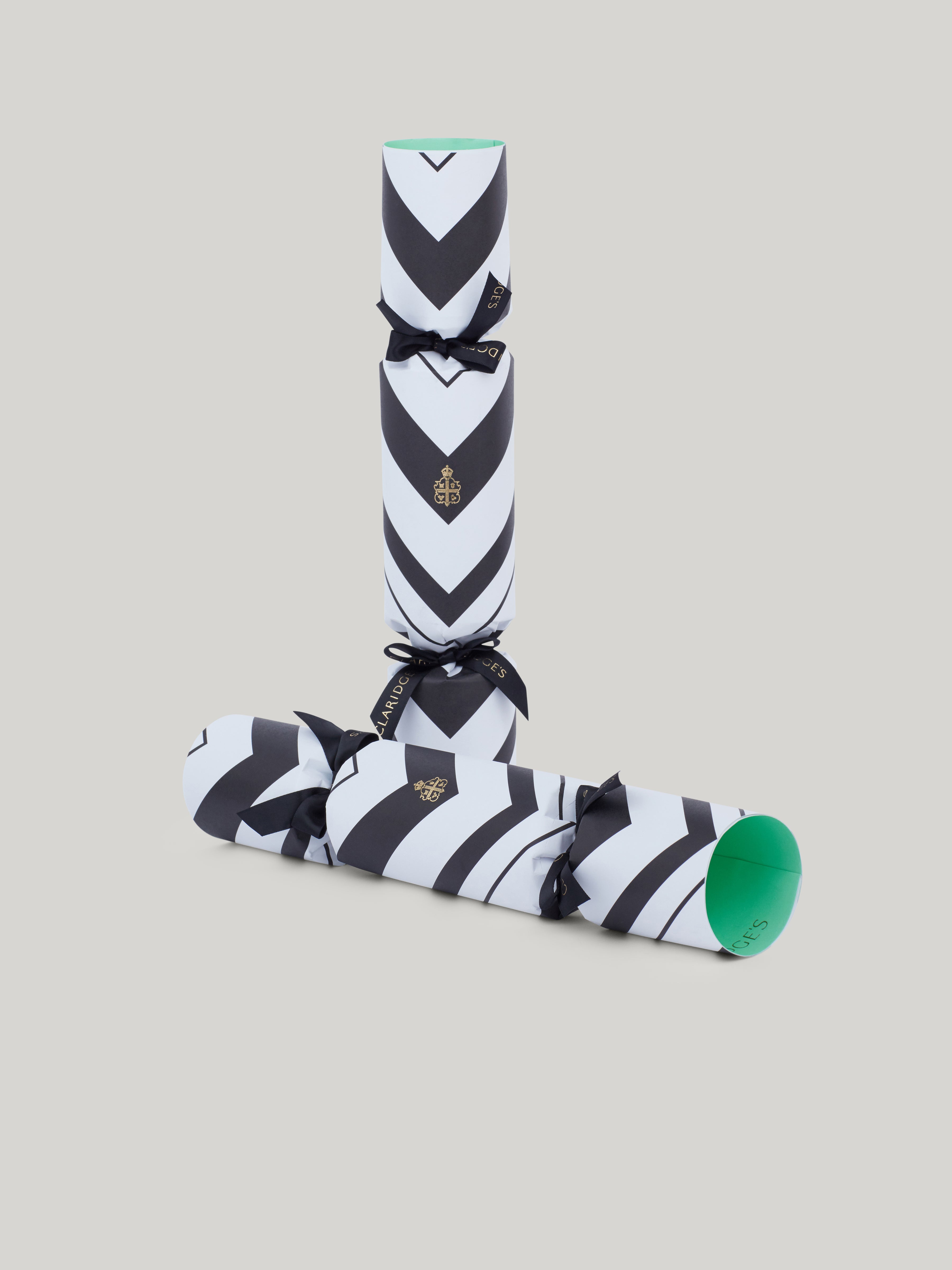 Claridge's Christmas crackers are handmade in England, Presented in a black box with 6 crackers, each one in the hotel's iconic black and white chevron design